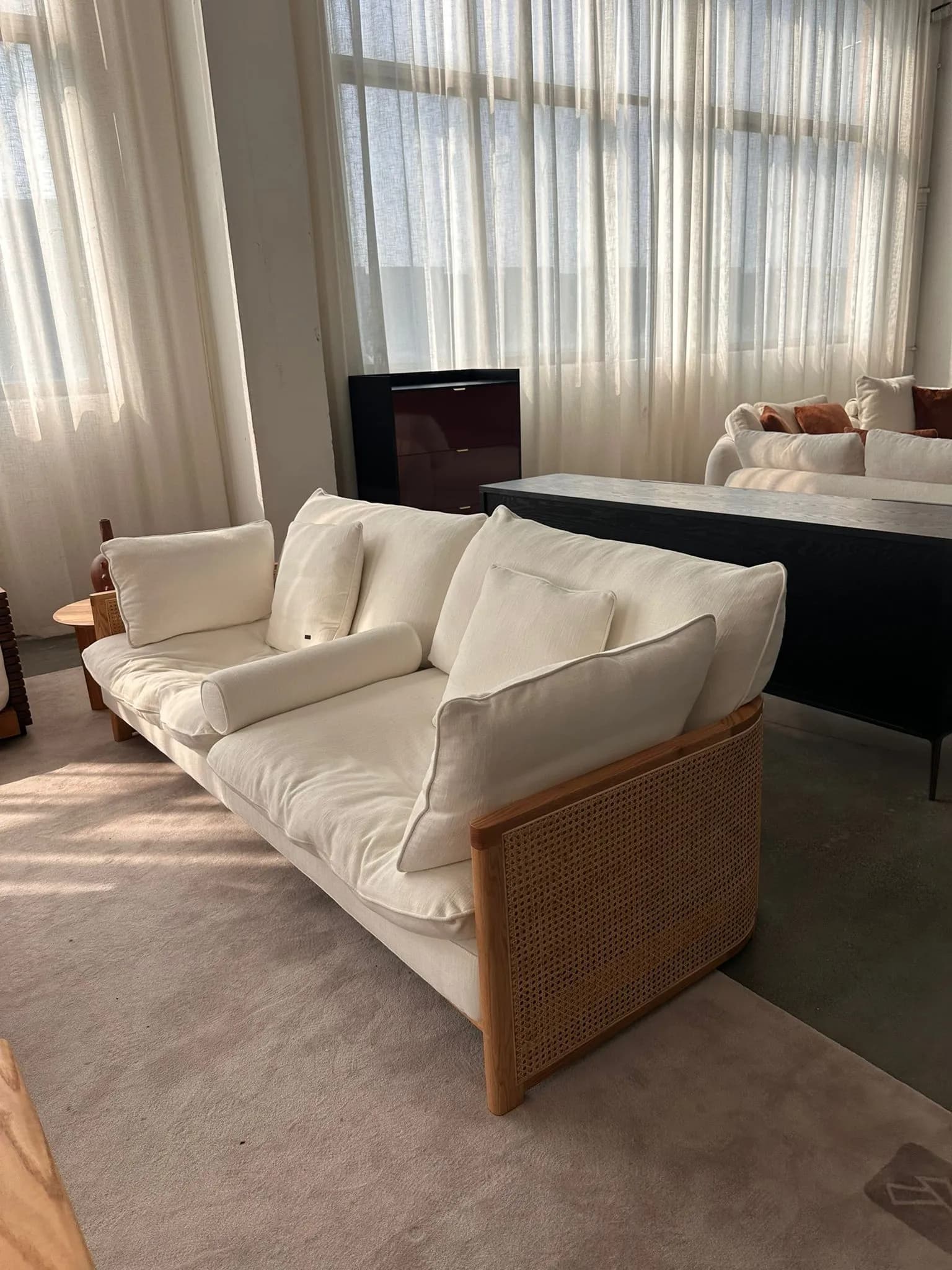 Rattan Lounge Chair — Wood frame with rattan sides and cream linen upholstery