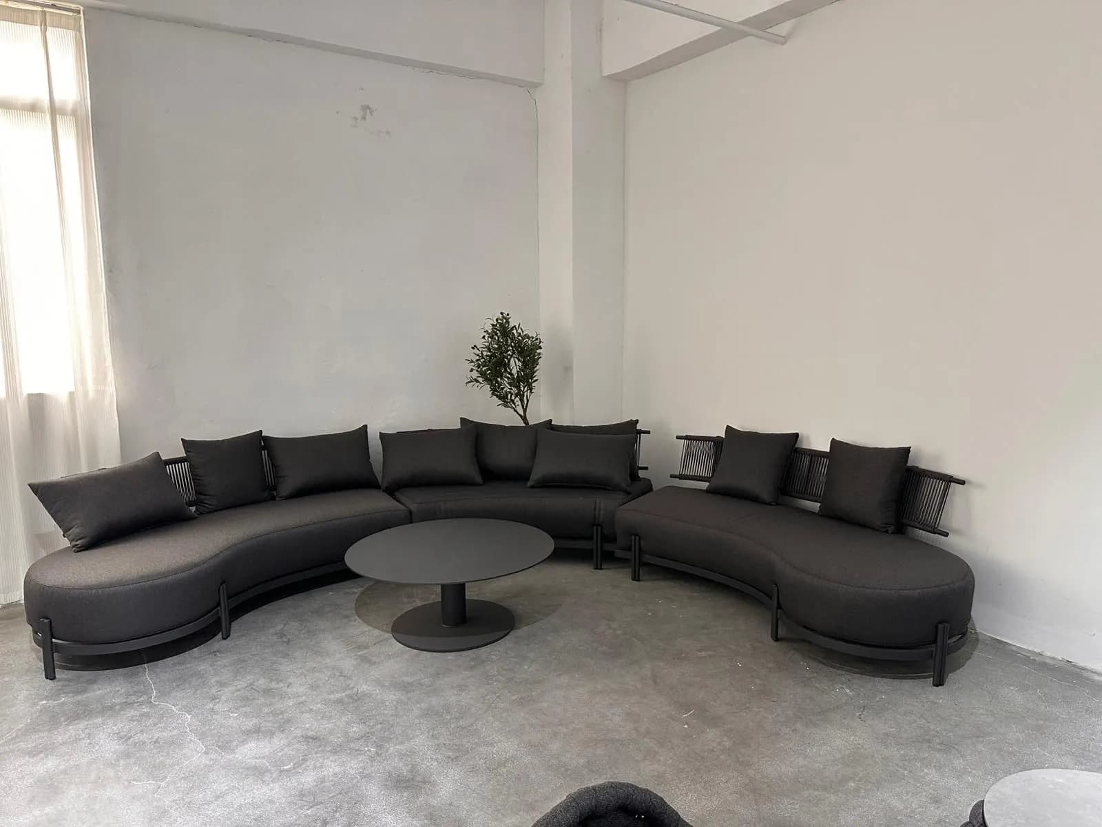 Curved Modular Sectional — Dark fabric upholstery with metal frame